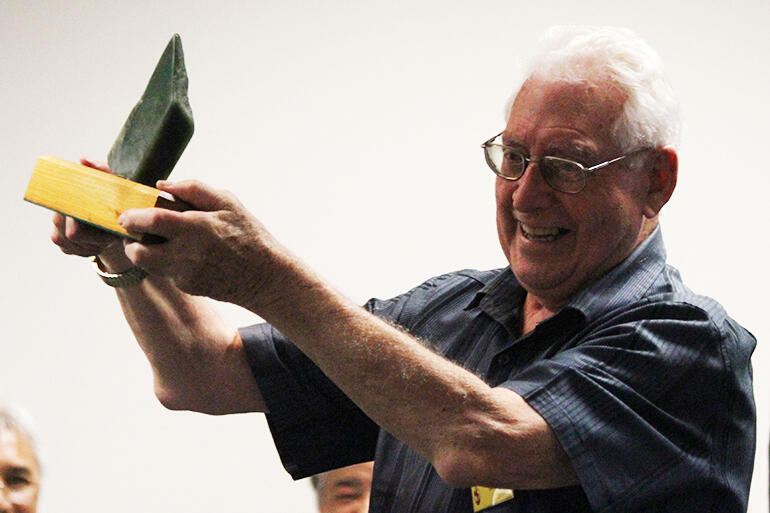 Stuart Hartley, of Perth, holding aloft a gift to mark his long service to Te Pihopatanga. He's helped plant a church in Western Australia.