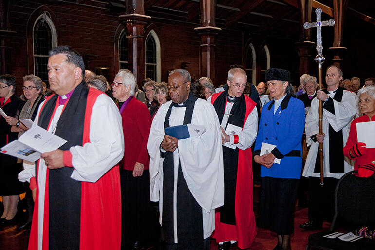 Bishop Kito Pikaahu leads the procession into the service. The ABC is accompanied by the Rev Iritana Hankins, of the Mother's Union in NZ.
