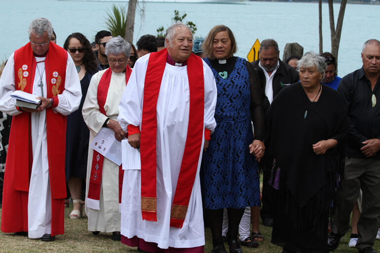 Bishop-elect Richard walks on to Onuku with his wife Mere and whanau. Bishop-elect Richard walks on to Onuku with his wife Mere and whanau.