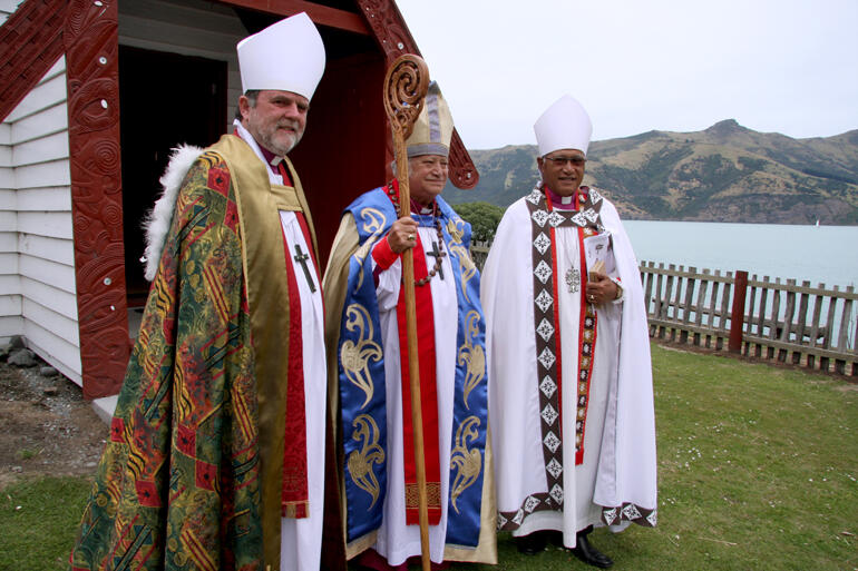 Our two archbishops flank the new bishop. That's Tuhiraka in the background. Our two archbishops flank the new bishop. That's Tuhiraka in the background.