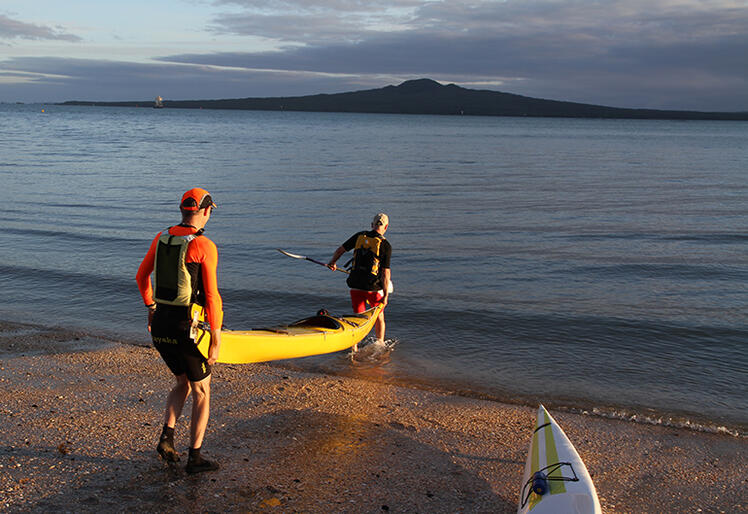 Wade in the water - Bishop Jim, helped by Arend Merrie (who joined Jim and John for the morning's paddle) launches his kayak.