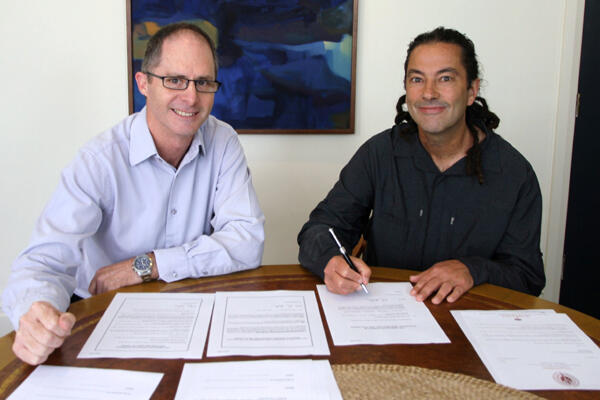 Anglican Church General Secretary Michael Hughes with Justin as he signs the paperwork that formally confirms him as Bishop.