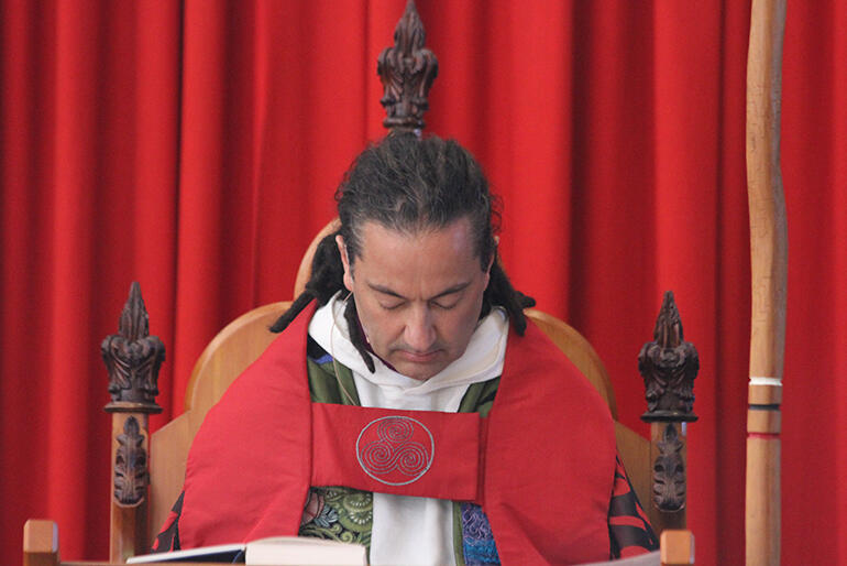 The bishop at prayer in his cathedra.