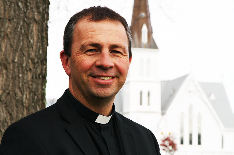 Bishop-elect Andrew Hedge, across the road from Cambrdge's iconic St Andrew's Church, where he has been Vicar for the past six years.