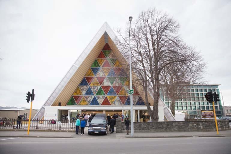 The hearse waits outside the Transitional Cathedral. The hearse waits outside the Transitional Cathedral.