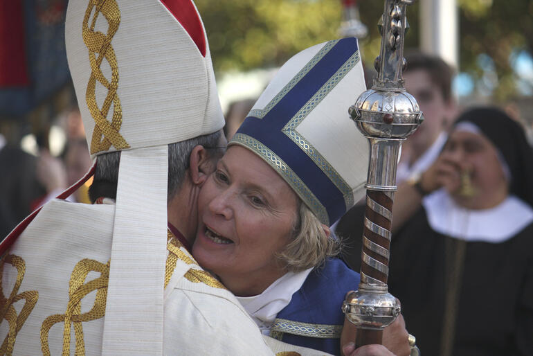 Bishop Victoria embraces Archbishop Roger Herft from Perth.