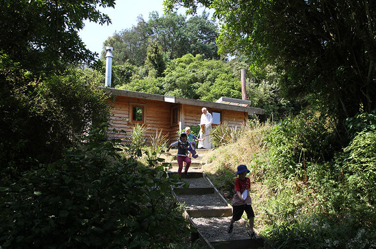 The Chapel of Tarore stands on a knoll, and is reached by a winding path through the trees from the main community houses. The Chapel of Tarore stands on a knoll, and is reached by a winding path through the trees from the main community houses.