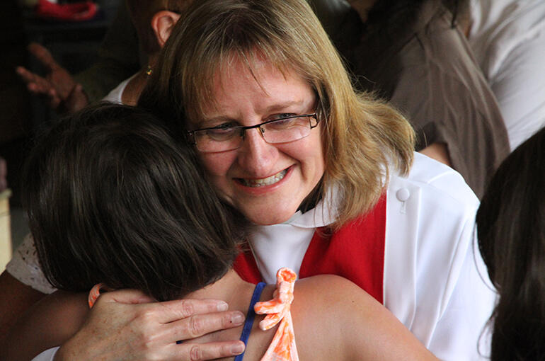 The Rev Karen Kemp - our new priest and Dean of the Tikanga Pakeha students at St John's College - embraces a young friend. The Rev Karen Kemp - our new priest and Dean of the Tikanga Pakeha students at St John's College - embraces a young friend.