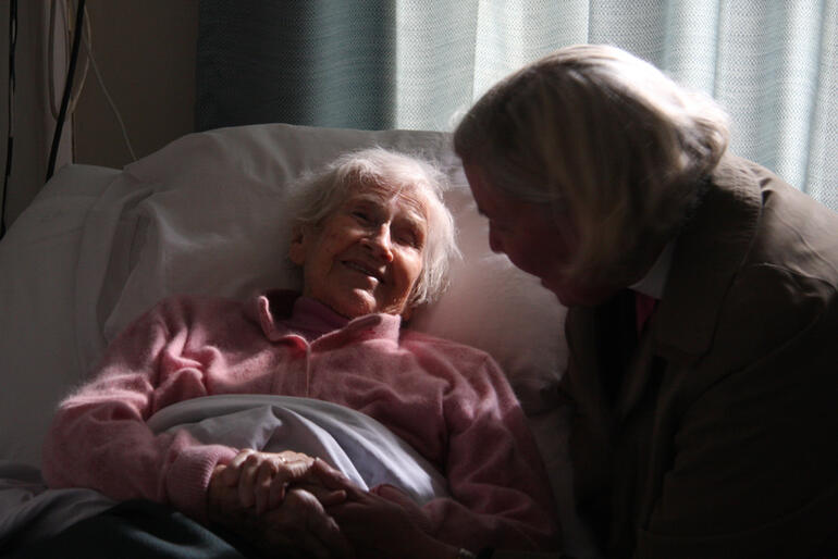 Bishop Victoria chat with Mrs Reena Thompson, a Churchill Courts resident whose husband Roger was a well-known vicar in the diocese.