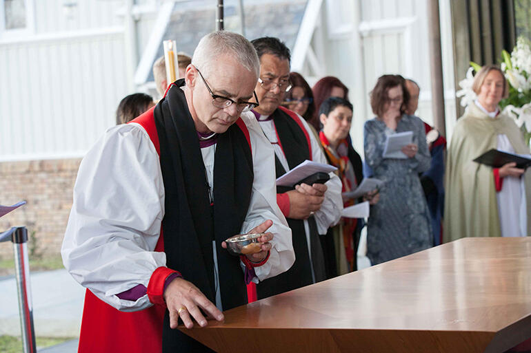 Bishop Jim White blesses the altar in the new chapel.