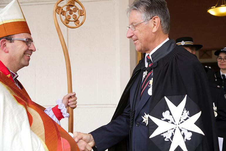 Mr Gary Salmon, of the Order of St John, congratulates the new bishop.