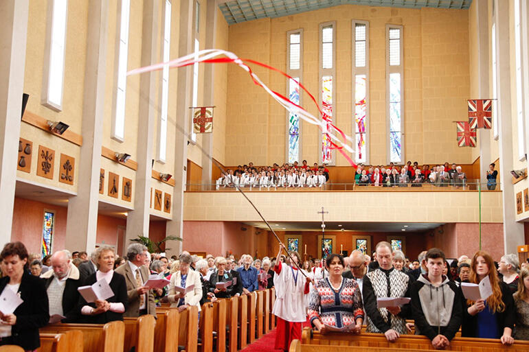 Streamers waving, the procession into the cathedral begins. Streamers waving, the procession into the cathedral begins.