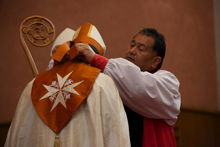 The Maltese Cross - the 900-year-old symbol of the order of St John - embroidered on the new bishop's hood. The Maltese Cross - the 900-year-old symbol of the order of St John - embroidered on the new bishop's hood.
