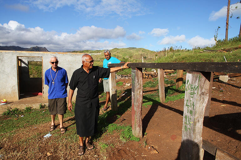 Archbishop Halapua inspects the remains of the school dormitory. That's Mike Hawke at left, and John Simmonds, Diocesan Secretary, at right.
