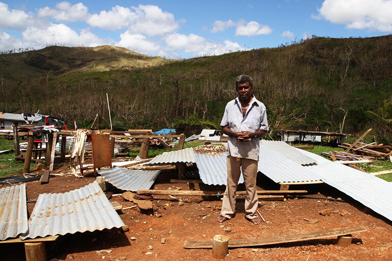 Simione Ravu stands where his house once stood.