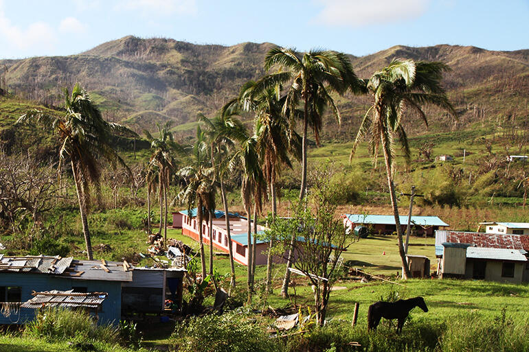 The pink building, at the centre, is the nearest school to Maniava - and it's had its roof torn off.