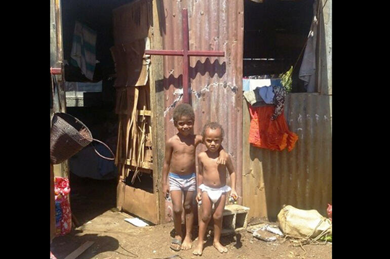 The old rugged cross stands over two youngsters from the Seaside family.