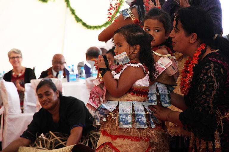 Sara and Agnes Tu'inukuafe receiving assurance from their mum Ilima before they dance the ta'olunga before the Queen Mother.