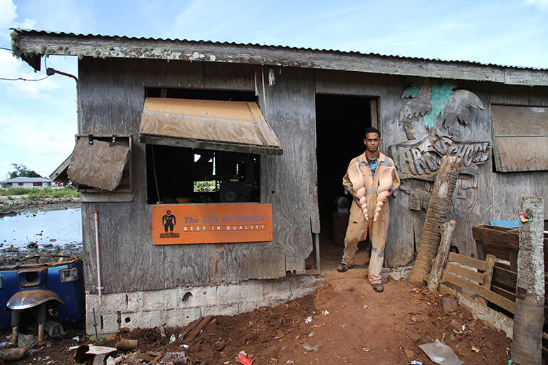 Sione Filiai outside the workshop where the new altar furniture was carved. The workshop sits in the swamps not far from downtown Nuku'alofa. 