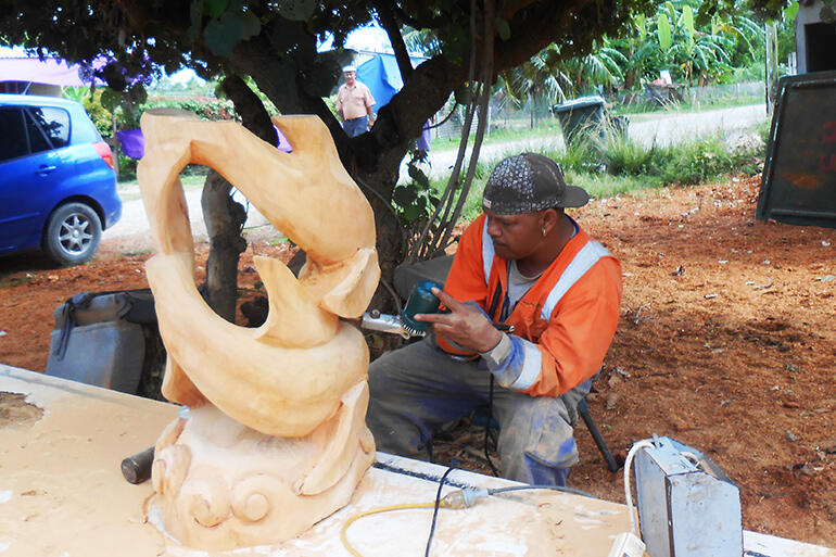 Timote Maamaloa at work, al fresco, on one of the new altar stands. Photo courtesy of Sue Halapua.