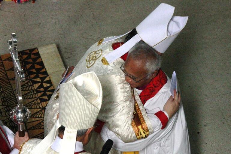 Archbishop David embraces his new brother archbishop. Archbishop David embraces his new brother archbishop.