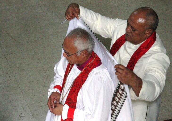 Archdeacobn Tui Finau of Tonga drapes the cope over Bishop Winston's shoulders.