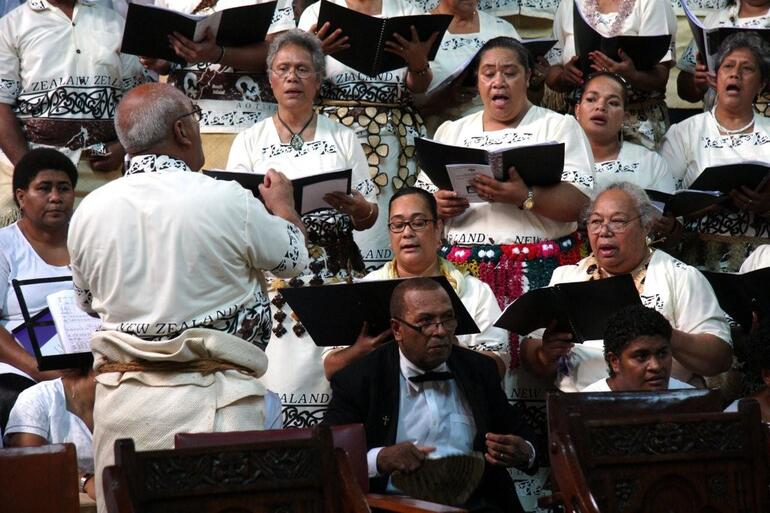Fr Tomu has a spell while the choir from the Ofa ki he Laumalie Ma'oni'oni, the Tongan Anglican church in Otahuhu, takes a turn.