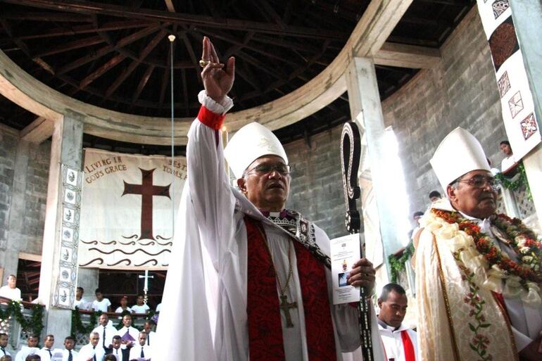 The service complete, Archbishop Winston confers his blessing on the congregation. The service complete, Archbishop Winston confers his blessing on the congregation.