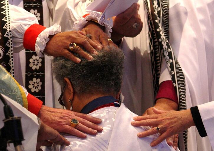 The laying on of hands, the passing on of the priesthood.