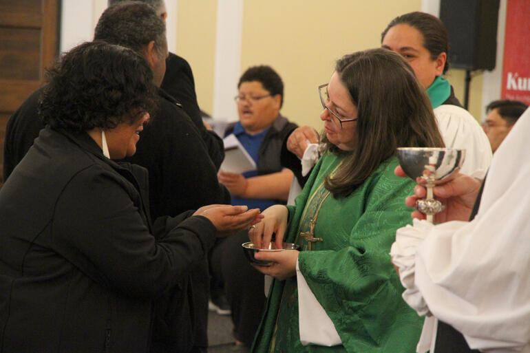 AILI members greet one another amidst a 'matrix of relations': Rev Shari Roy receives from Archbishop Marinez Basotto.