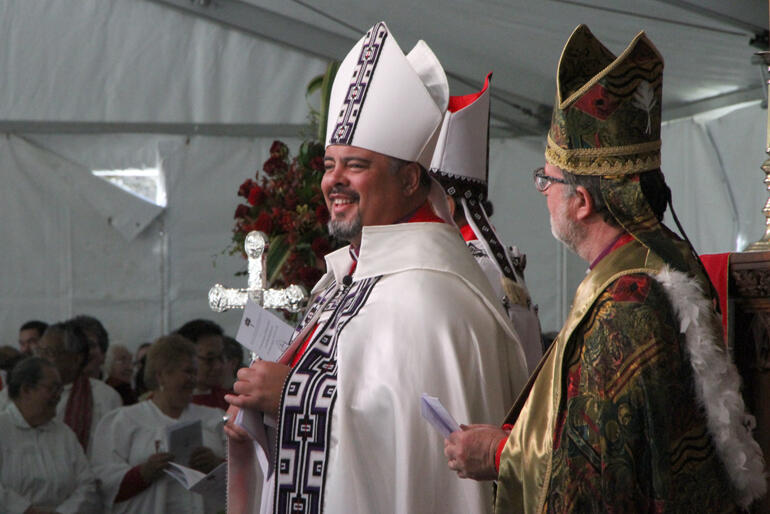 Archbishop Don pauses proceedings to make sure everyone is smiling.