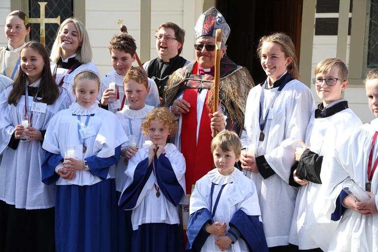 Bishop Waitohiariki stands amongst the children and young people who served as acolytes at her ordination. Bishop Waitohiariki stands amongst the children and young people who served as acolytes at her ordination.
