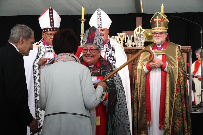 Members of St Michael's Palmerston North present the new bishop's pastoral staff. Members of St Michael's Palmerston North present the new bishop's pastoral staff.