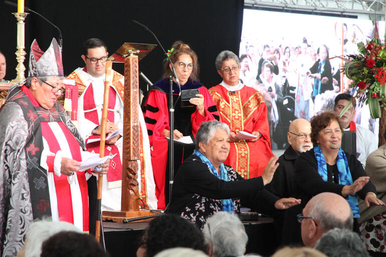 Ngāti Kahungunu kaumatua come forward to surround and affirm Bishop Wai (in blue scarves) Manu Vercoe and Charmaine Bartlett. 