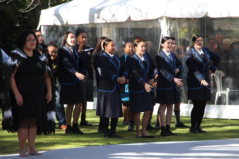 Raumahora Waata of Rangitane welcomes the visitors alongside students from Te Kura Kaupapa Māori o Wairarapa as the pōwhiri begins. 