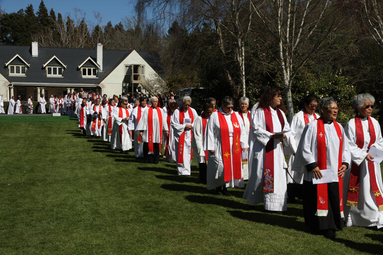 Some of the 218 robed clergy that turned out process toward the worship tent. Some of the 218 robed clergy that turned out process toward the worship tent.