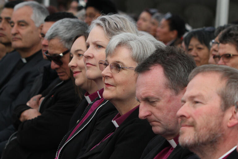 Three women sit on the bench of bishops at the morning's pōwhiri: Bishop Eleanor Sanderson, Bishop Riscylla Shaw & Bishop Denise Ferguson.