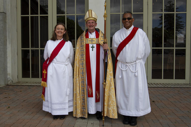 New Auckland deacons Emily Paterson and Kirsten Willenberg stand with Bishop Ross outside Holy Trinity Cathedral on Saturday 18 Dec 2021.