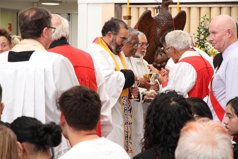 Archdeacon Hirini Kaa joins fellow ministers of communion in the sanctuary. Archdeacon Hirini Kaa joins fellow ministers of communion in the sanctuary.