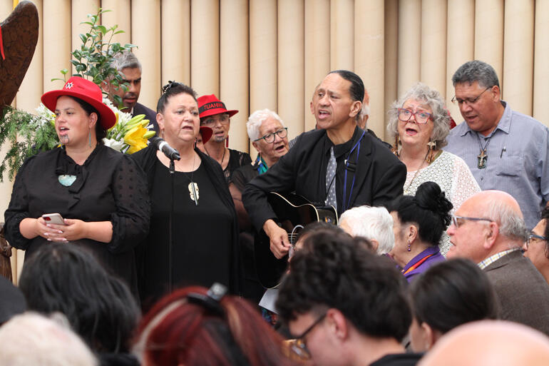 Musicians from Tuahiwi and supporters offer a waiata to send Bishop Richard on the next part of his final journey. Musicians from Tuahiwi and supporters offer a waiata to send Bishop Richard on the next part of his final journey.