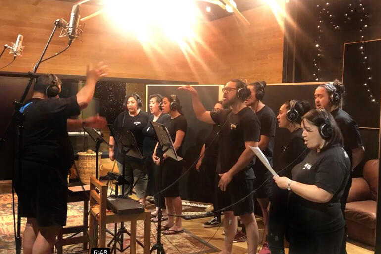 Tawhai Tapene pitches in with conducting from the choir during a video of one of the first himene to go on record.