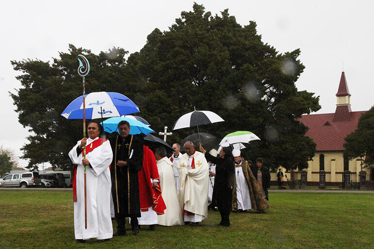 Heavy rain fell as the archbishops and altar party processed from Toko Toru Tapu to the marquee.