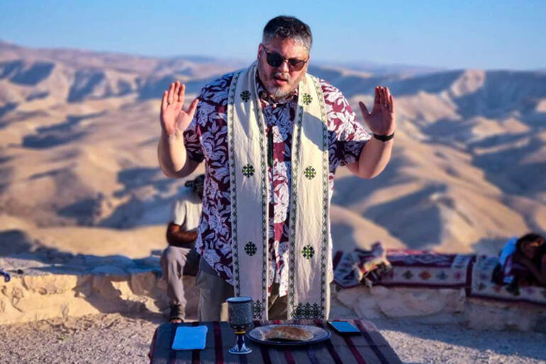 Te Rau Tumuaki Archdeacon Michael Tamihere celebrates the Eucharist looking across the Judean wilderness.