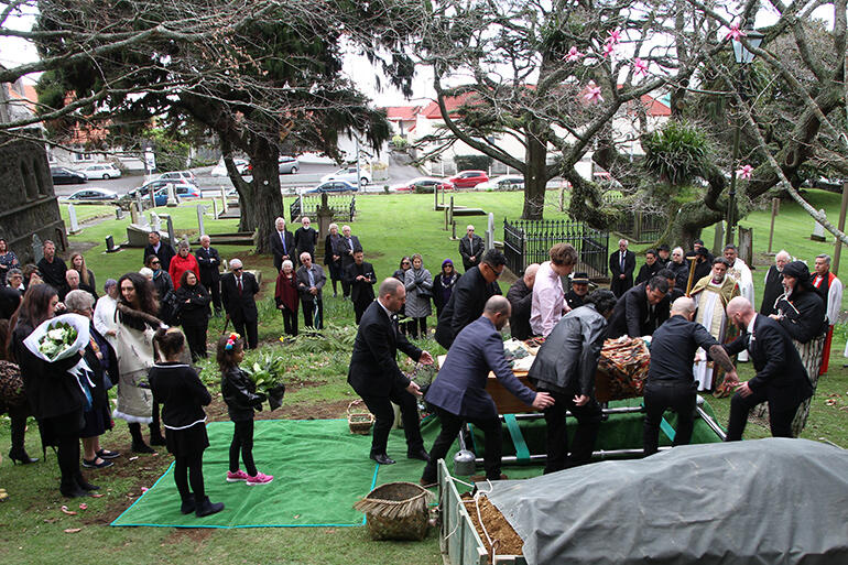 Maori and Pakeha mingle at Tiki's graveside.