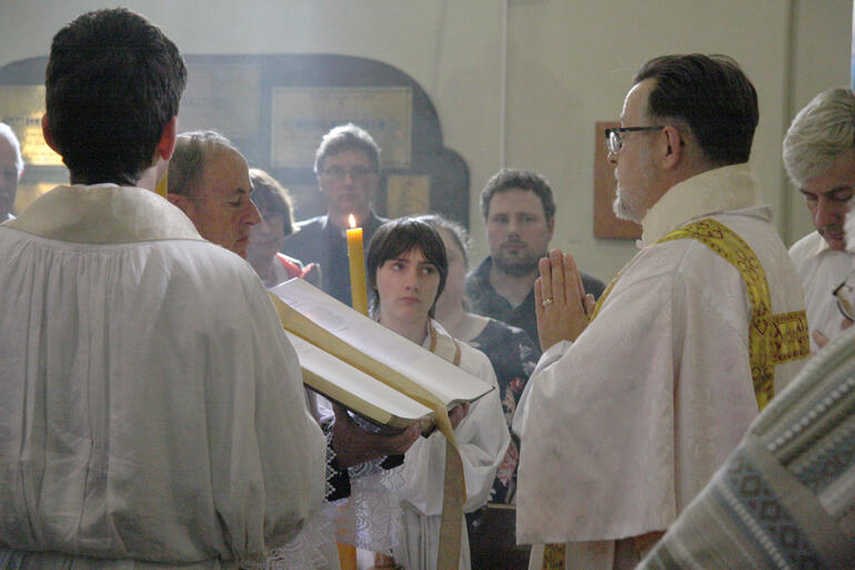 Vicar of Cambridge the Ven Malcom French readies himself to read the gospel.