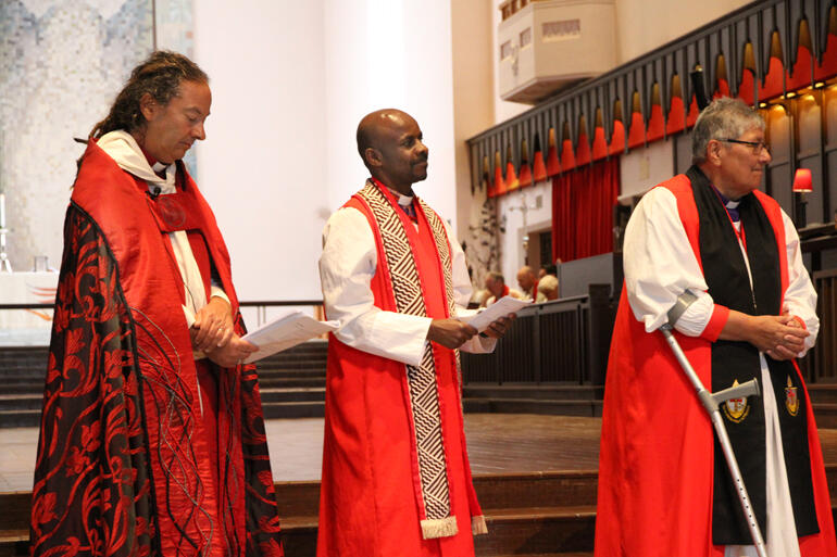 Bp Justin Duckworth, Bp Steve Maina and Bp Waitohiariki look on as Bishop Anashuya receives her vestments.
