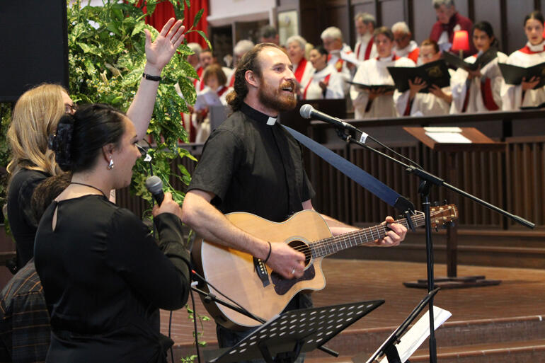 (L-R) Jordi Haami-Rerekura, Katie Thomas & Sam Tovey-Duckworth lead singing for the worship band. 