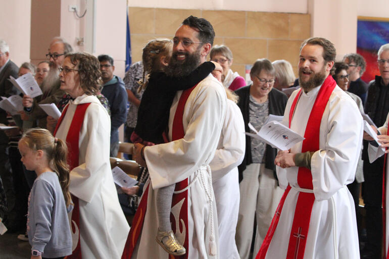 Urban Vision whānau process into the Cathedral in support of Bishop-elect Ana and her family.