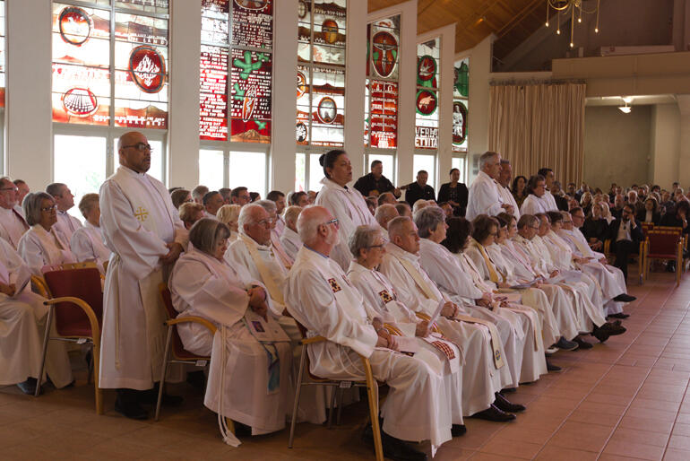 Clergy from Te Pihoptanga o Te Tai Tokerau rise to support Bishop Kito Pikaahu in song. Clergy from Te Pihoptanga o Te Tai Tokerau rise to support Bishop Kito Pikaahu in song.