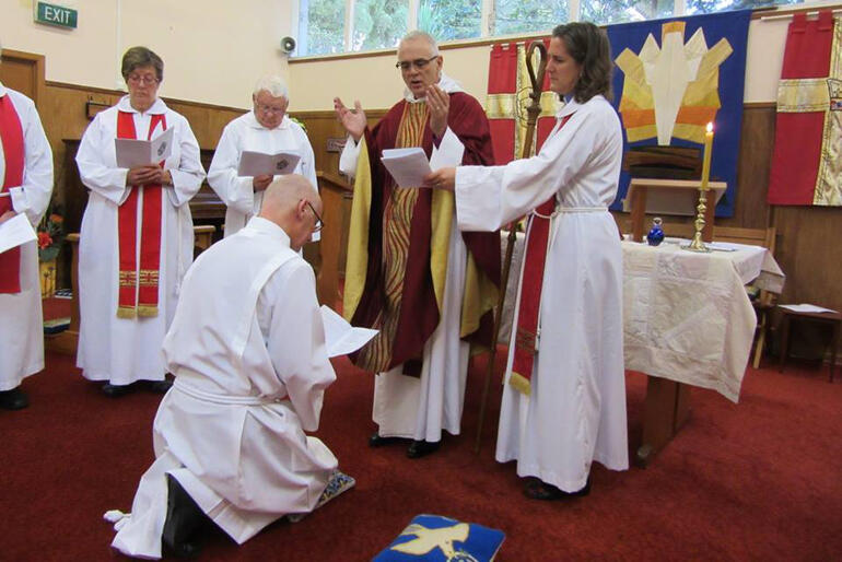 Bishop Jim prays during David Crawley's ordination to the Holy Order of Deacons at St Francis' Titirangi in 2015